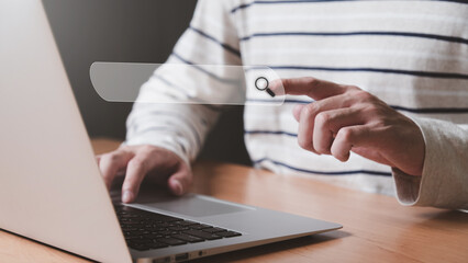 Selective focus at the search box with blurred background of men hand and laptop with internet router while search for information from internet and website. SEO and search engine for online marketing