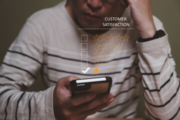 Selective focus at men hand while type on smartphone to give customer satisfaction feedback for poor service quality that need meet expectation or standard of the service. Bad experience feedback.