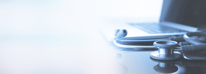 healthcare and medicine background. Medical stethoscope and laptop computer on table with copy space. Online medical, e-health education, Health business web banner