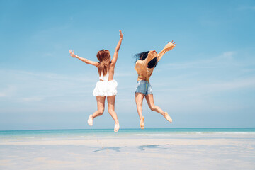 Obraz premium Happy girl jumping on the beach, Beach summer holiday sea people concept