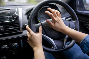 Driver presses the horn of the car to avoid road accident. Stress and aggressive driving on city...