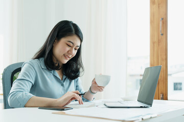 financial, Planning, Marketing and Accounting, portrait of Asian employee checking financial statements using documents and calculators and computer at work