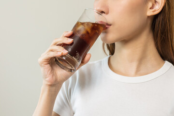 Thirsty, attractive asian young woman, girl drink or sip, holding a glass of cold sparkling water with ice in hand, refreshness people, isolated on white background. Temptation of food, health care.