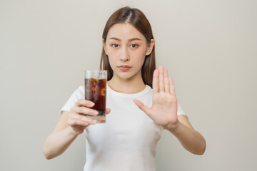 Diet, Dieting. Attractive asian young woman, girl push out cold cola, refuse carbonated soft drink soda, sparkling water by her hand. Health care, healthy lifestyle concept, avoid limits sweet sugar.