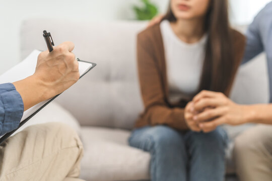 Psychology, depression asian young couple, patient consulting problem mental health with psychologist, psychiatrist at clinic together, husband encouraging by holding hand of wife, therapy health care