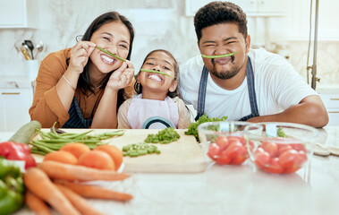 Cooking, family and comic portrait in kitchen for crazy, goofy and silly fun together with smile. Food, asian and bonding with funny vegetable face of happy mother, father and child in house. - obrazy, fototapety, plakaty