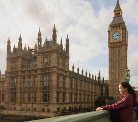 Asian female tourists Travel in London, England at the Big Ben Clock Tower area.Concept of foreign tourism After the epidemic situation of covid. - obrazy, fototapety, plakaty