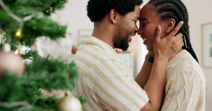 Happy couple face, christmas holiday and smile hug and spend time together in living room at home. Holiday celebration, smiling black man and woman love romance bond hugging by festive tree in house