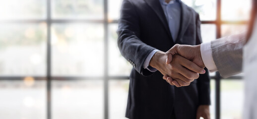Business handshake for teamwork of business merger and acquisition,successful negotiate,hand shake,two businessman shake hand with partner to celebration partnership and business deal concept	 - obrazy, fototapety, plakaty