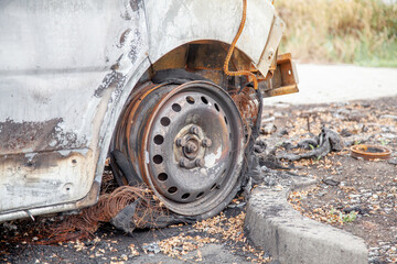 Minibus after a fire, burnt body and interior of the car. Burnt rusty car after fire or accident. Car after the fire, crime of vandalism, riots. Arson car. Accident on the road due to speeding.