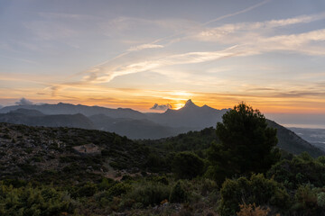 Fototapeta na wymiar Silhouettes of mountains in the landscape at sunrise