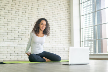 Latin woman teaching yoga online