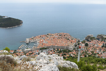 The old town of Dubrovnik (Dalmatia, Croatia) lying in the Adriatic Sea as seen from a mountain. With on the left Lokrum Island.
