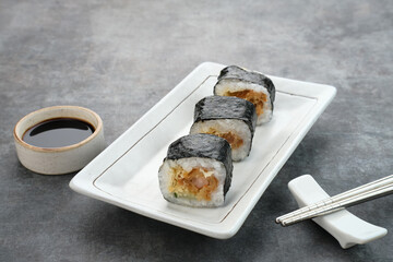 Sushi Rolls with nori served on white plate.
