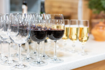 Many glasses of different wine in a row on bar counter