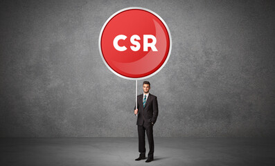 Obraz premium Young business person holdig traffic sign