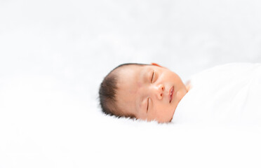 Cute newborn baby is peaceful sleep on white background.