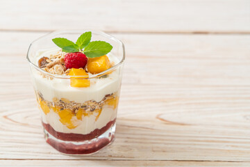 homemade mango and raspberry with yogurt and granola
