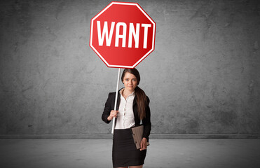 Young business person holding road sign