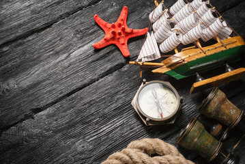 Sea travel concept. Pirate concept background. Mooring rope, compass, ship, binoculars and starfish...