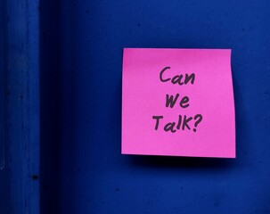 Pink note on blue walll with text written CAN WE TALK , concept of boss , manager, partners or...