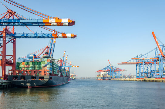 Wide shot of container vessel and harbour facilities at a the Waltershof Eurogate and Burchardkai container terminal in the port area of Hamburg, Germany