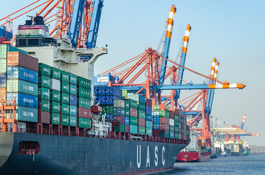 Closeup of large container vessel and harbour facilities at a the Waltershof Eurogate container terminal in the port area of Hamburg, Germany
