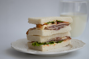 Close up Black Forest ham sandwich on white background