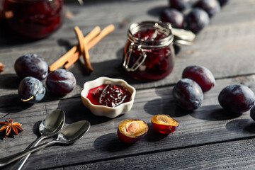 plum prune fruit jam with spices on a dark wooden background, the concept of preservation at home