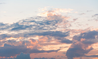 Delicate sunrise in the sky with clouds. Copy space. Cloudy background