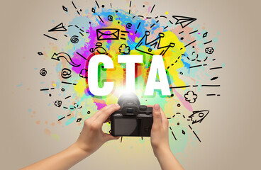Close-up of a hand holding digital camera with abstract drawing