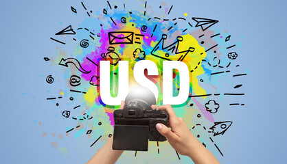 Close-up of a hand holding digital camera with abstract drawing