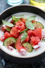 Close-up of cold summer soup made of fresh watermelon, cucumber and buttermilk, vertical shot, selective focus