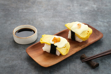 Egg Sushi Rolls or tamago sushi with red caviar, Japanese food
