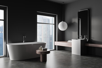 Naklejka na ściany i meble Corner view on dark bathroom interior with bathtub, mirror, sink