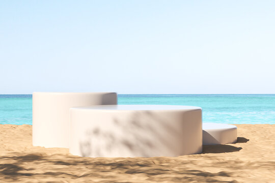 White podiums at the beach, ocean view. Mockup for product display