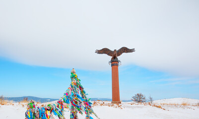 Bronze sculpture of an eagle in the Tazheranskaya steppe. The shaman eagle column nearthe lake...