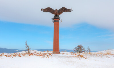 Bronze sculpture of an eagle in the Tazheranskaya steppe. The shaman eagle column nearthe lake Baikal