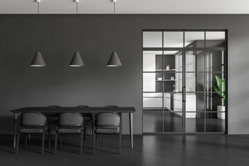 Grey living room interior with table and seats, glass doors and kitchen room