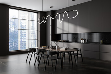 Modern kitchen interior with eating table and seats on tile concrete floor