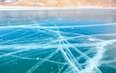 Beautiful drawings on ice from cracks and bubbles of deep gas on surface - Baikal lake in winter, Siberia