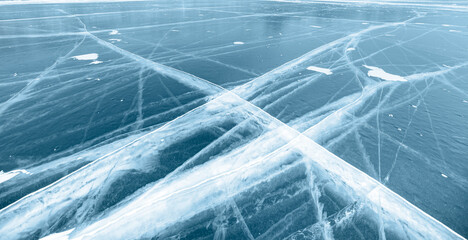 Beautiful drawings on ice from cracks and bubbles of deep gas on surface - Baikal lake in winter, Siberia