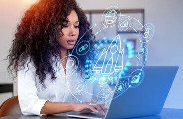 African businesswoman using laptop, startup rocket hologram with helpdesk