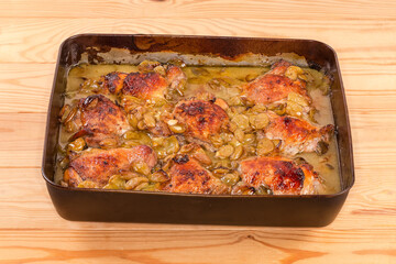 Chicken thighs baked with grape in the metal oven tray