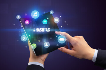 Businessman holding a foldable smartphone concept