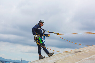 Male workers clear rope access wearing safety first harness rope safety line