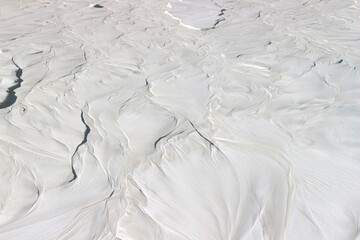 wet white sand, cement with a beautiful pattern close-up is used as a background
