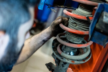 Fototapeta na wymiar Mechanic hands maintenance suspension