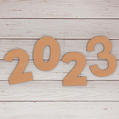 Cardstock Numbers 2023 Happy New Year Sign over table. 3d Rendering