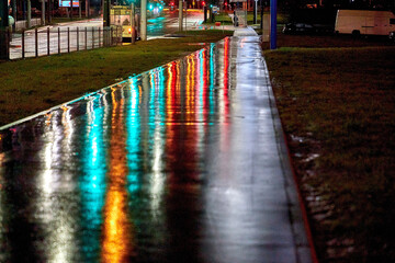 Wet city street after a night of rain with street lights